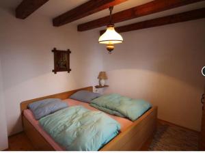 a bed in a room with two pillows on it at Vlašićki Konak in Vlasic