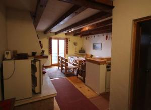 a kitchen and dining room with a table and chairs at Vlašićki Konak in Vlasic +23 photos