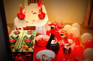 a table with a cake and wine glasses and balloons at Victoria Lake View Guesthouse & Safaris in Entebbe