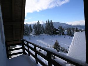a view from a balcony of a ski resort in the snow at Vlašićki Konak in Vlasic