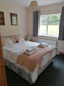 Glenarm的住宿－Fern house，一间卧室配有一张床,上面有两条毛巾