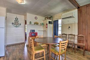 a kitchen and dining room with a table and chairs at Pet-Friendly Beachfront Dent Cabin w/ Grill! in Dent