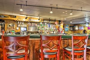 a bar with wooden bar stools in a restaurant at Pet-Friendly Beachfront Dent Cabin w/ Grill! in Dent +17 photos