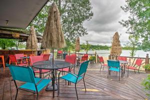 a group of tables and chairs on a deck next to the water at Pet-Friendly Beachfront Dent Cabin w/ Grill! in Dent