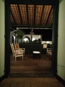 an open door to a patio with chairs and a table at Casa Frankie in São Luís