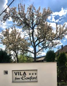 a sign for a tax store with trees in the background at Vila FAN Confort in Vişeu de Sus