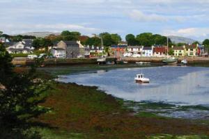 
a small boat floating on top of a body of water at Tigh Noor - Escape to Kinvara by the sea! in Galway
