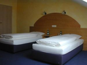 two beds sitting next to each other in a room at Hotel Pit Lane "Home of Motorsport" in Nürburg