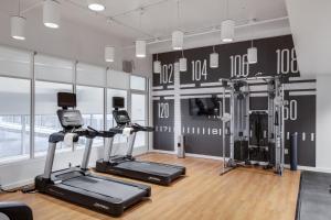 a gym with treadmills and ellipticals in a room at Hotel Indigo - Memphis Downtown, an IHG Hotel in Memphis
