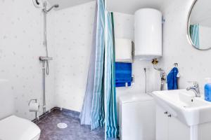a bathroom with a shower curtain and a sink at Cosy stay in southern Malmo in Malmö +7 photos