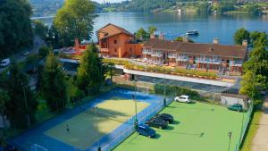 an aerial view of a tennis court in front of a house at Hotel L'Approdo in Pettenasco