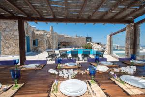 a table set up for a wedding on a patio at Villa Boufla in Agios Ioannis Mykonos