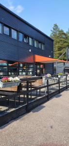 a group of picnic tables in front of a building at Arkadia Hotel & Hostel in Helsinki