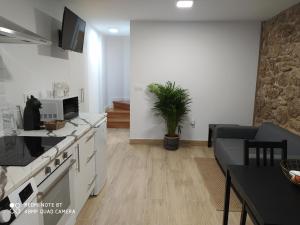 a kitchen and living room with a couch and a table at Dúplex Costa de Fisterra I in Finisterre