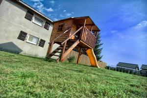 a house with a staircase on the side of a building at Zacisze pod Laskiem in Karwieńskie Błoto Pierwsze +2 photos