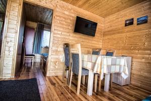 una sala da pranzo con tavolo e sedie in una cabina di Zacisze pod Laskiem a Karwieńskie Błoto Pierwsze
