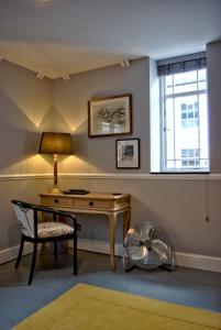 a room with a desk and a chair and a window at City Studios in Ely