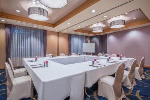 a large meeting room with a large white table and chairs at ANA Crowne Plaza Kanazawa by IHG in Kanazawa