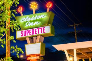 a neon sign for a chicken over superrite at Classen Inn in Oklahoma City