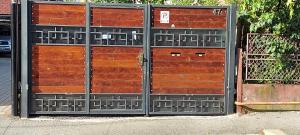 a pair of wooden doors on a building at NIKAS APARTMENT in Sibiu
