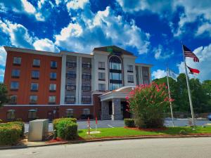 een hotel met een Amerikaanse vlag ervoor bij Holiday Inn Express & Suites Wilson-Downtown, an IHG Hotel in Wilson