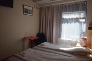 Postel nebo postele na pokoji v ubytování Arkadia Hotel & Hostel