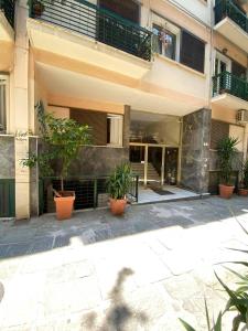 a building with potted plants in front of it at Check Point - Plaka in Athens