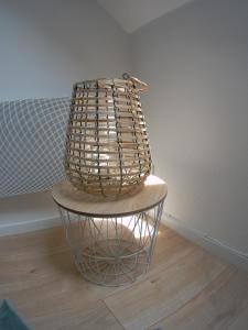 a basket sitting on a table in a room at Au bonheur des Anes - Gite Maya in Le Quesnoy-en-Santerre