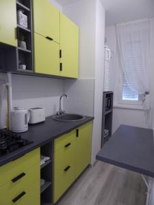 A kitchen or kitchenette at Pisztácia 2020 Apartman