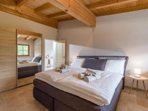 a bedroom with a large bed with two pillows on it at Appartement Zirbe in Ellmau
