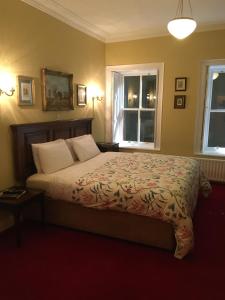 a bedroom with a bed and a dresser at Red Setter Townhouse Bed & Breakfast in Carlow