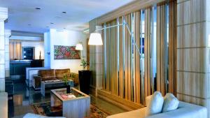 a living room with a couch and a table at Castel Plaza Hotel in Resende