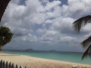a view of a beach with two ships in the water at Annabelle's in Saint James