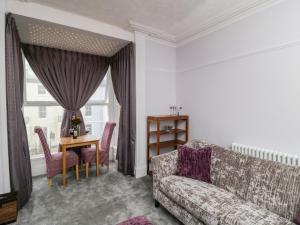 a living room with a couch and a table at Abbey Vista in Whitby