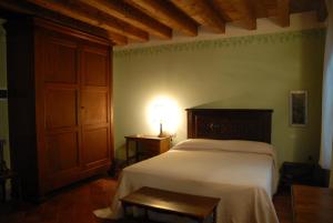a bedroom with a bed with a lamp on it at Agriturismo La Costa in Crema