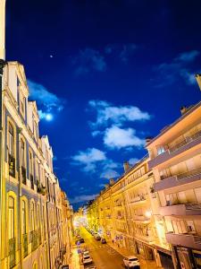 a view of a street at night with buildings at Sri-Indo Guest House in Lisbon