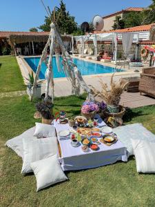 a table with food on it next to a pool at Kemerlihan Deluxe Hotel in Alacati