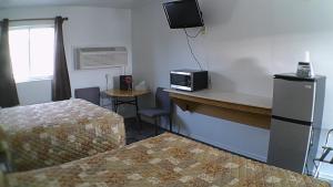 a room with two beds and a counter with a microwave at Americas Best Value Inn Salmon in Salmon
