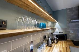 a kitchen with a counter with glasses on a shelf at 92 Union Terrace in York