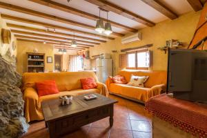 a living room with a couch and a table at Casas Rurales Picachico in Laroya
