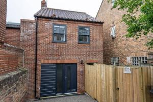 a brick house with a garage and a fence at 92 Union Terrace in York