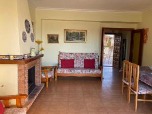 un salon avec un canapé et une cheminée dans l'établissement 1era linea de playa VILLA MARGARET Cullera Marenyet, à Cullera