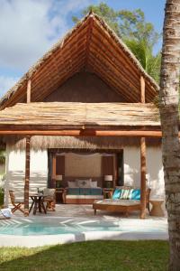 a large pavilion with a bed and a patio at Viceroy Villas, Riviera Maya in Playa del Carmen