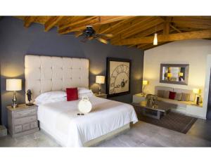 a bedroom with a large white bed and a ceiling at Hotel Spa Sitio Sagrado in Tepoztlán