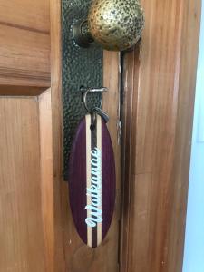 a wooden door with a football memorabilia on it at Cedar House in Gisborne