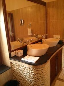 a bathroom with two sinks and a mirror at Jasvilas in Jaipur