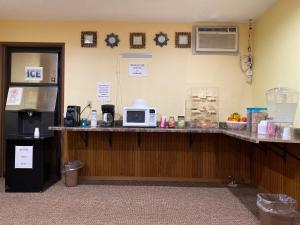 a kitchen with a counter with a microwave on it at AmeriVu Inn in Prentice