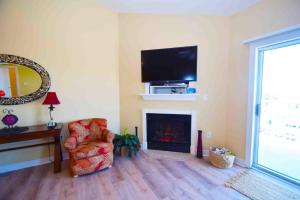 un soggiorno con camino e televisione di Mariner'S Watch 404 Condo a Ocean City