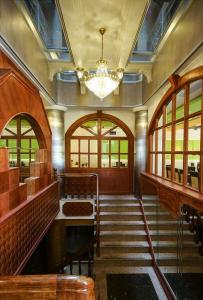 a room with stairs and a chandelier and windows at Royal Hotel in Magong