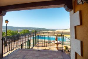 a balcony with a view of a swimming pool at El Mirador de la Serrania in Villalba de la Sierra